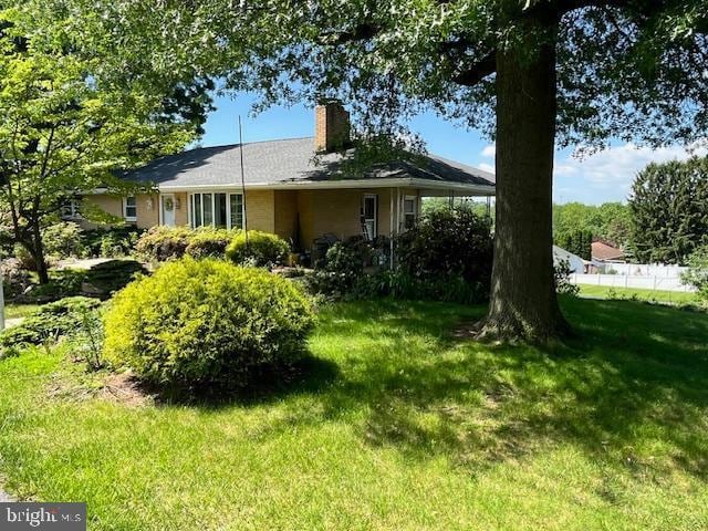 1155 Loop Dr, Harrisburg, PA 17112 - view of front of property featuring a chimney and a front lawn