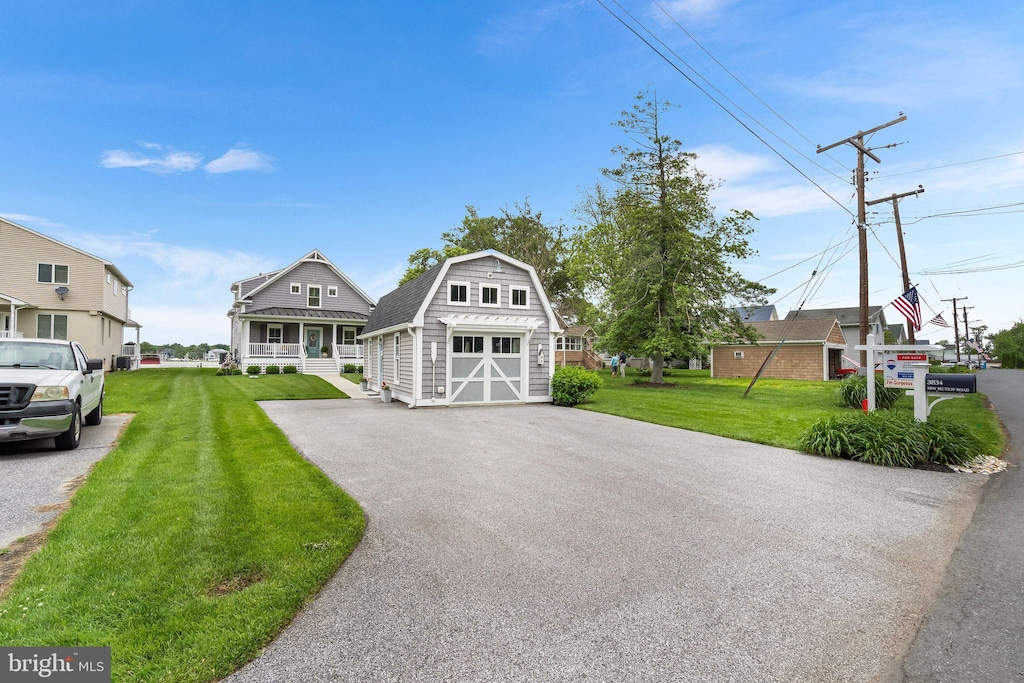 3834 New Section Rd, Middle River, MD 21220 - view of front of house featuring an outbuilding, a garage, a front yard, asphalt driveway, and a gambrel roof