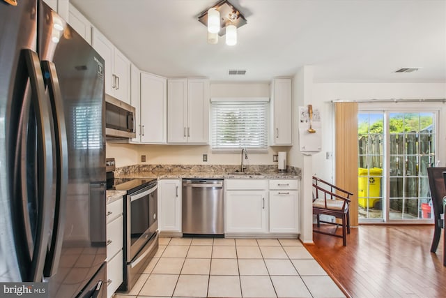 1650 Woodtree Ct E, Annapolis, MD 21409 - kitchen featuring appliances with stainless steel finishes, a sink, plenty of natural light, and white cabinetry