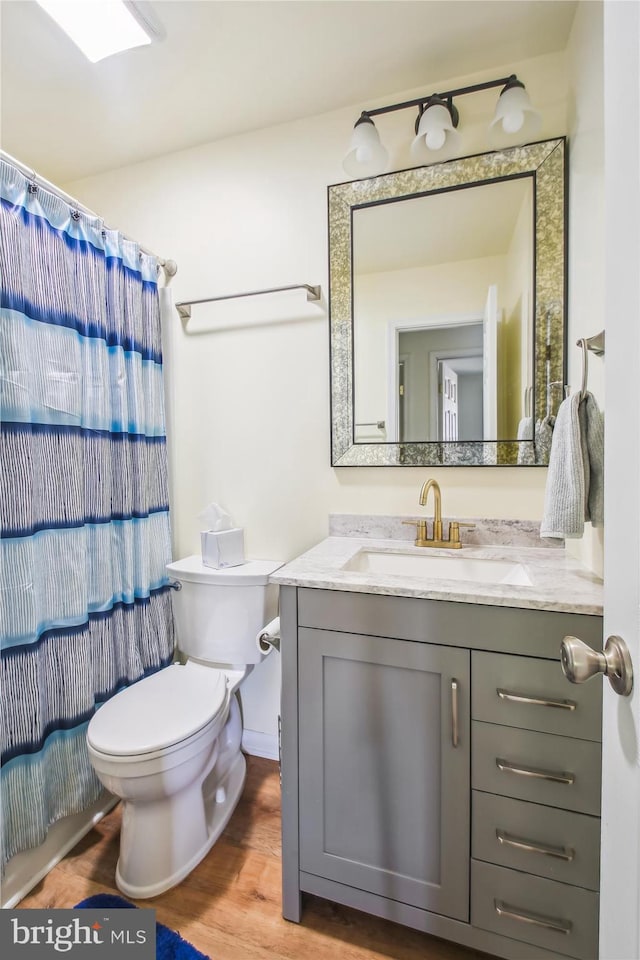 1650 Woodtree Ct E, Annapolis, MD 21409 - bathroom featuring toilet, wood finished floors, vanity, and a shower with curtain