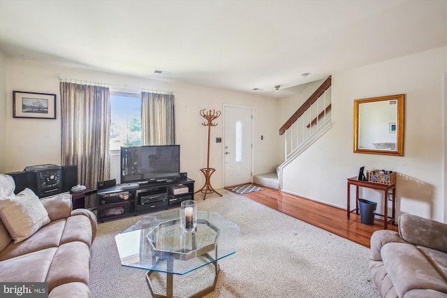 1650 Woodtree Ct E, Annapolis, MD 21409 - carpeted living room featuring stairs and wood finished floors