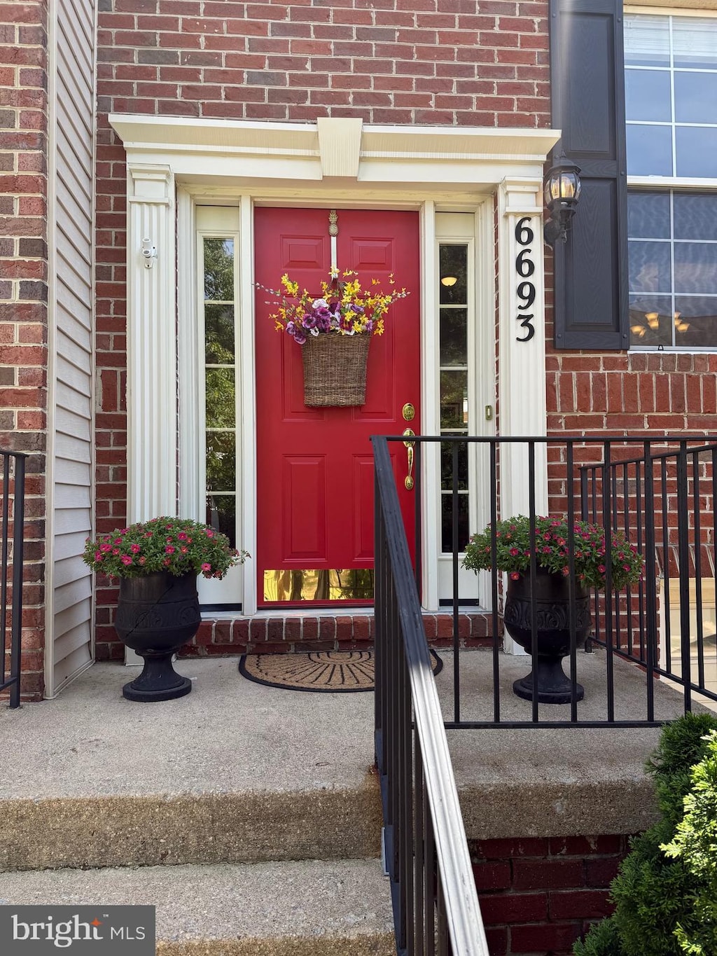 doorway to property with brick siding
