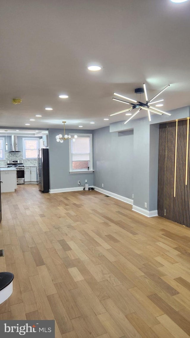 3203 W Allegheny Ave, Philadelphia, PA 19132 - below grade area featuring a chandelier, freestanding refrigerator, light wood finished floors, recessed lighting, and baseboards