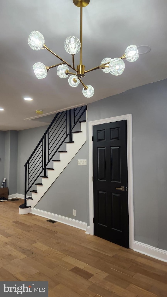 3203 W Allegheny Ave, Philadelphia, PA 19132 - entryway with stairs, a chandelier, baseboards, and wood finished floors
