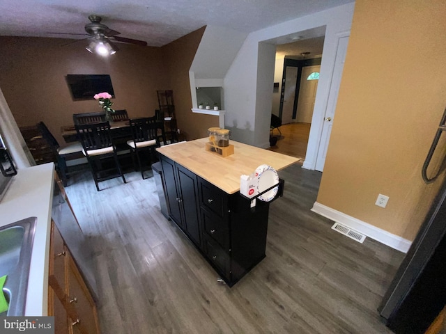 941 Chestnut Manor Ct, Curtis Bay, MD 21226 - kitchen with dark cabinetry, ceiling fan, wood finished floors, wooden counters, and baseboards