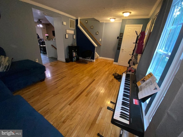 941 Chestnut Manor Ct, Curtis Bay, MD 21226 - living area featuring ornamental molding, light wood finished floors, plenty of natural light, stairs, and a ceiling fan