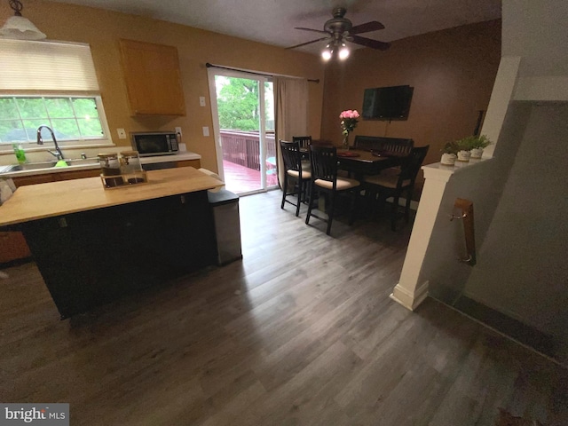 941 Chestnut Manor Ct, Curtis Bay, MD 21226 - kitchen featuring a sink, wood finished floors, light countertops, and healthy amount of natural light