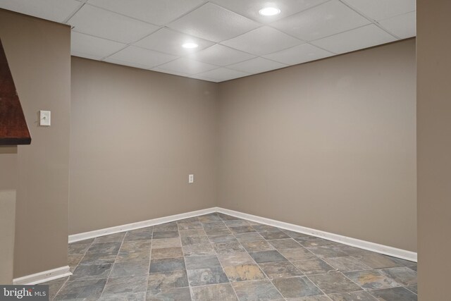 spare room featuring baseboards, recessed lighting, and stone finish flooring