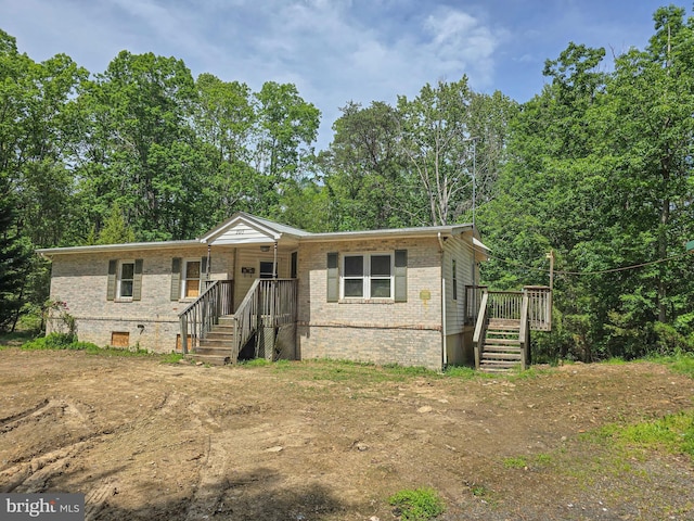 view of front facade featuring brick siding and stairway