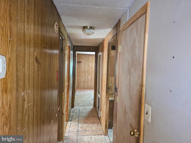 hall featuring wood walls