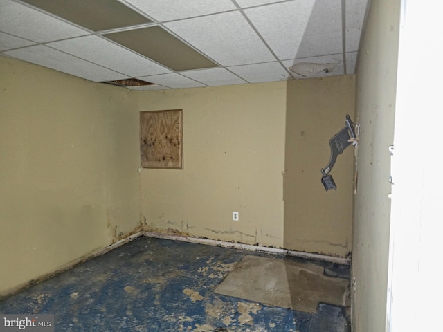 unfurnished room with a drop ceiling