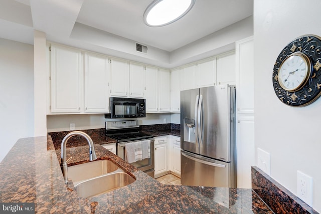6914 Ellingham Cir Unit C, Alexandria, VA 22315 - kitchen with stainless steel appliances, dark stone countertops, white cabinets, and light tile patterned flooring