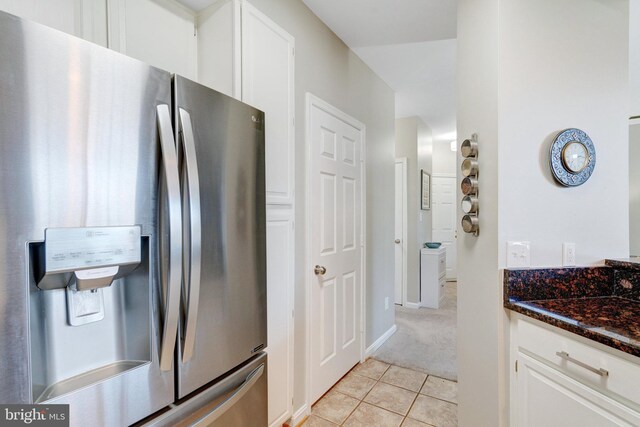 6914 Ellingham Cir Unit C, Alexandria, VA 22315 - kitchen featuring stainless steel fridge with ice dispenser, light tile patterned flooring, white cabinets, light colored carpet, and dark stone counters