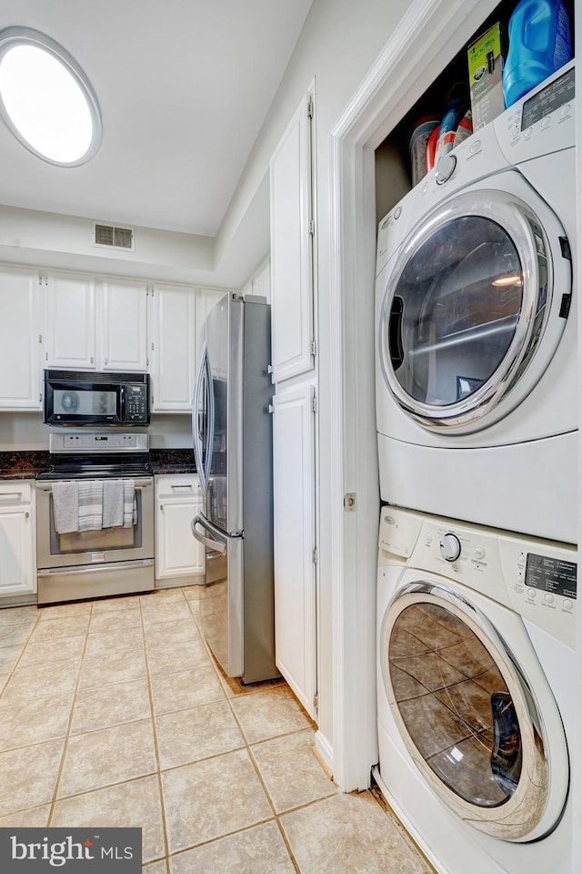 6914 Ellingham Cir Unit C, Alexandria, VA 22315 - laundry room with stacked washing machine and dryer and light tile patterned flooring