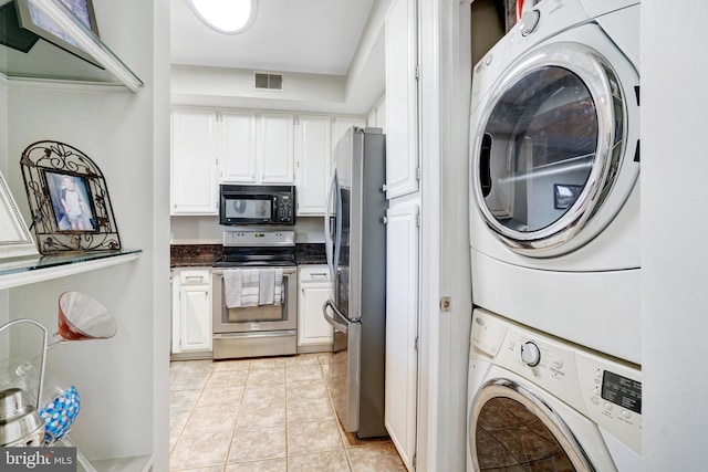 6914 Ellingham Cir Unit C, Alexandria, VA 22315 - laundry area with stacked washer / drying machine and light tile patterned floors