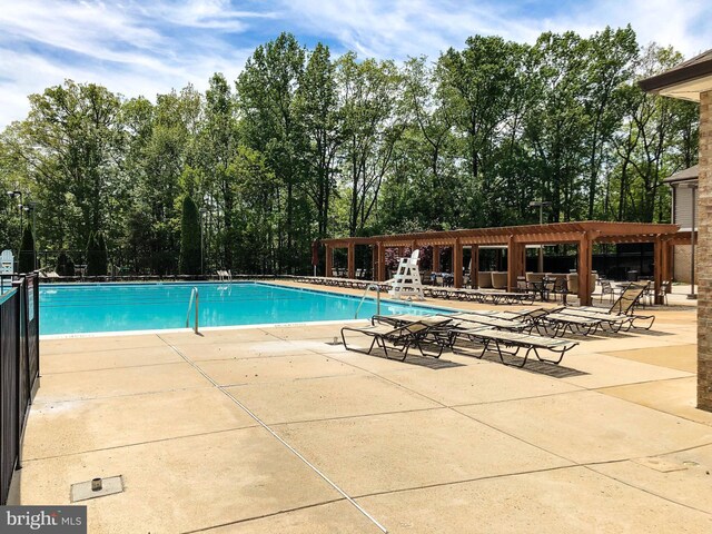 6914 Ellingham Cir Unit C, Alexandria, VA 22315 - community pool featuring a patio area, a pergola, and view of wooded area