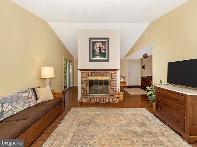 4310 Zircon Rd, Middletown, MD 21769 - living area with lofted ceiling, dark wood-style flooring, and a fireplace