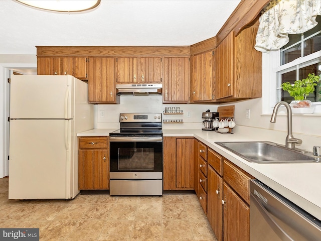 4310 Zircon Rd, Middletown, MD 21769 - kitchen featuring appliances with stainless steel finishes, under cabinet range hood, a sink, and light countertops