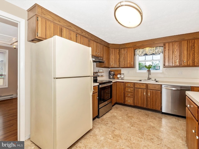 4310 Zircon Rd, Middletown, MD 21769 - kitchen featuring appliances with stainless steel finishes, a sink, brown cabinets, light countertops, and under cabinet range hood