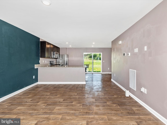 11044 Cross Fields Dr, Waynesboro, PA 17268 - kitchen with stainless steel appliances, dark wood finished floors, a peninsula, light countertops, and open floor plan