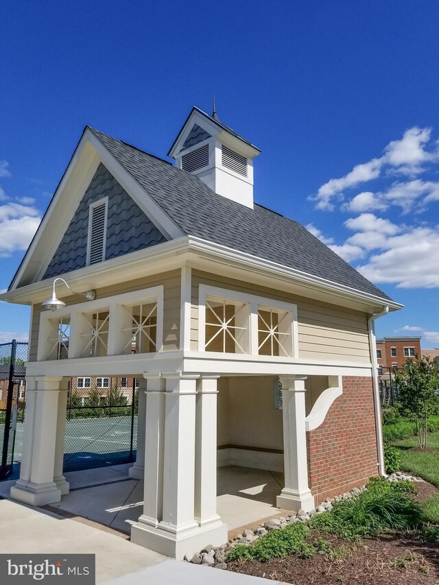 316 Parkview Ave, Gaithersburg, MD 20878 - view of property exterior featuring a shingled roof, brick siding, and fence