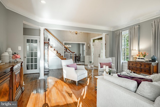 201 Ivystone Dr, Downingtown, PA 19335 - living room featuring decorative columns, ornamental molding, stairway, a decorative wall, and a chandelier