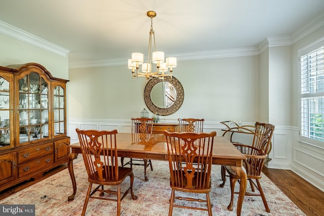 201 Ivystone Dr, Downingtown, PA 19335 - dining area with a chandelier, crown molding, wood finished floors, a wainscoted wall, and a decorative wall