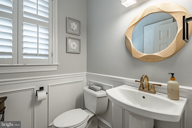 201 Ivystone Dr, Downingtown, PA 19335 - bathroom with a wainscoted wall, toilet, a sink, and a decorative wall