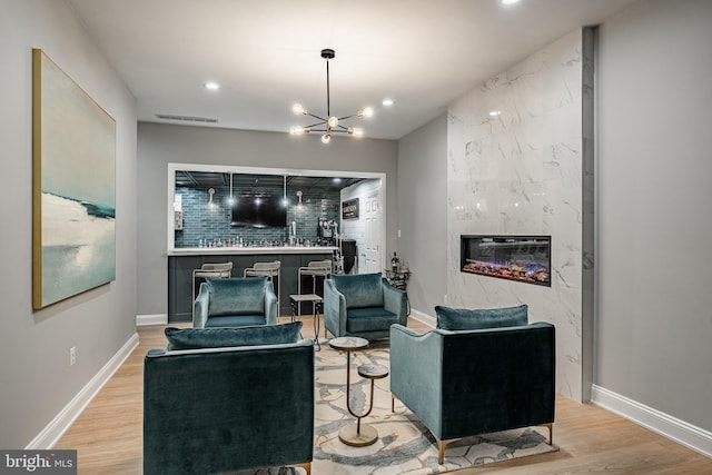 201 Ivystone Dr, Downingtown, PA 19335 - living area with light wood-type flooring, recessed lighting, a high end fireplace, a chandelier, and baseboards
