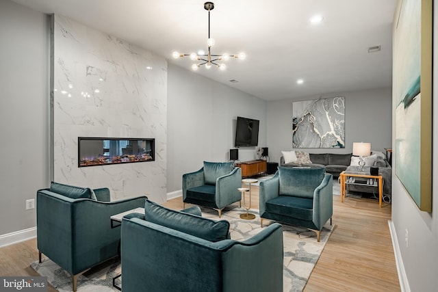201 Ivystone Dr, Downingtown, PA 19335 - living area featuring a high end fireplace, light wood-style floors, a chandelier, baseboards, and recessed lighting