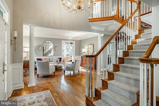 201 Ivystone Dr, Downingtown, PA 19335 - foyer entrance with stairway, wood-type flooring, a high ceiling, crown molding, and decorative columns