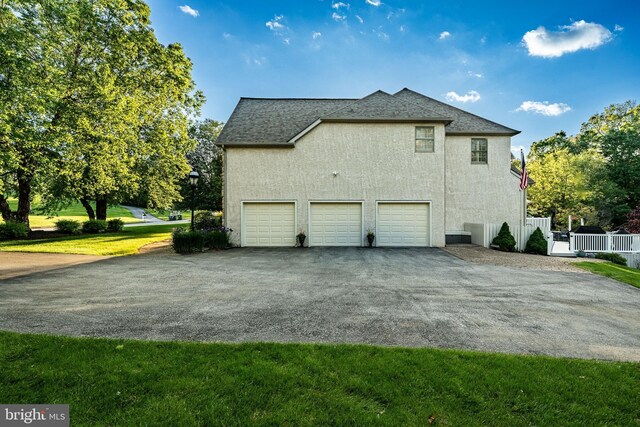 201 Ivystone Dr, Downingtown, PA 19335 - view of home's exterior featuring driveway, stucco siding, a garage, and roof with shingles