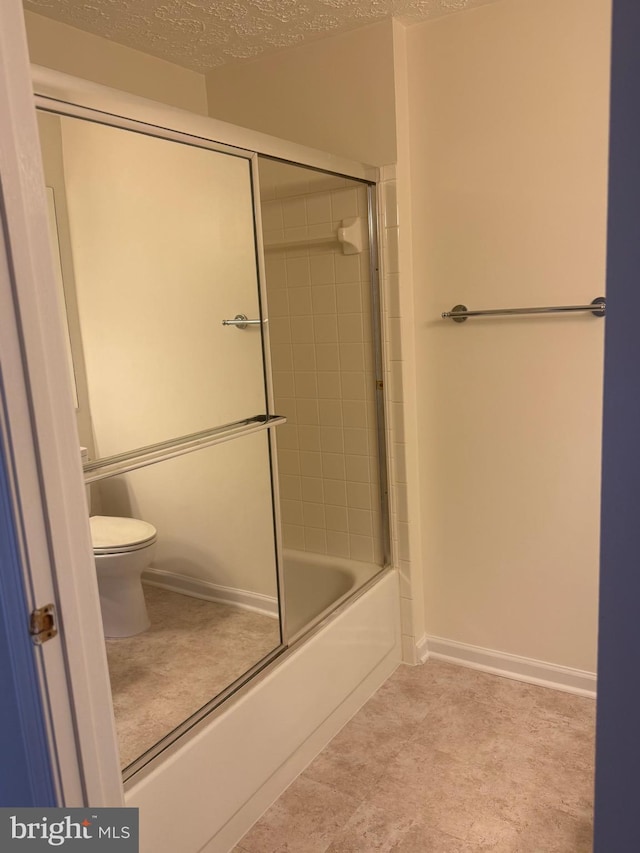 11002 Koman Cir, Manassas, VA 20109 - bathroom with a textured ceiling, toilet, and enclosed tub / shower combo