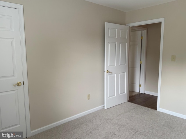 11002 Koman Cir, Manassas, VA 20109 - unfurnished bedroom with dark carpet and baseboards