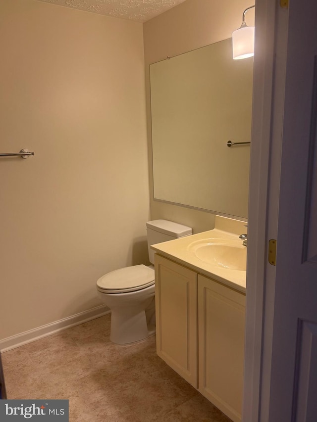 11002 Koman Cir, Manassas, VA 20109 - bathroom with vanity, toilet, a textured ceiling, and baseboards