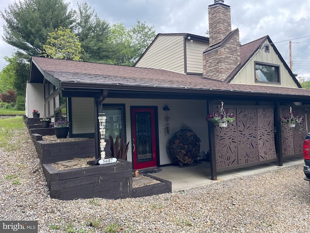 5607 Meridian Rd, Gibsonia, PA 15044 - view of front of property featuring a chimney, a porch, board and batten siding, and roof with shingles