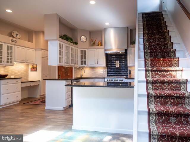 5607 Meridian Rd, Gibsonia, PA 15044 - kitchen with wall chimney exhaust hood, dark countertops, decorative backsplash, recessed lighting, and white cabinets