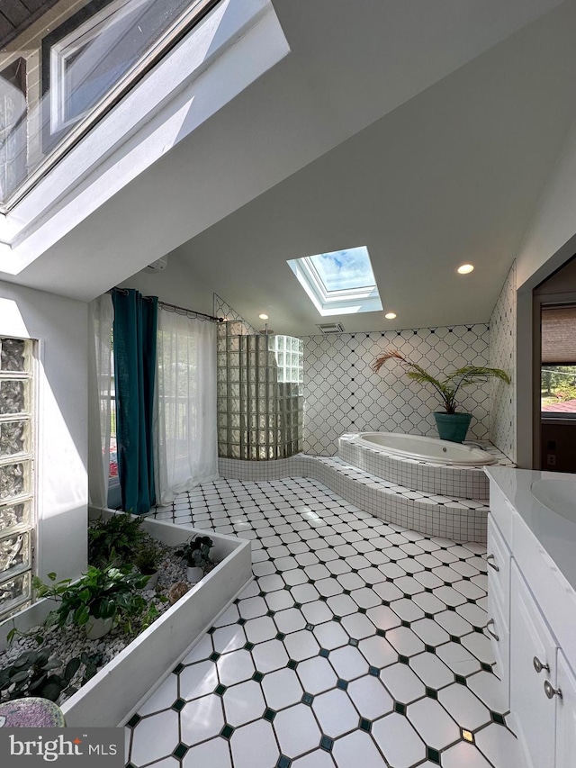 5607 Meridian Rd, Gibsonia, PA 15044 - full bath featuring a skylight, tiled tub, tile patterned floors, vanity, and recessed lighting