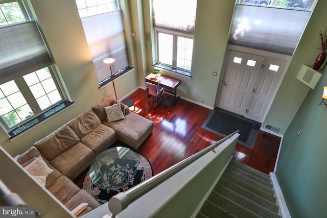living room featuring baseboards and hardwood / wood-style flooring