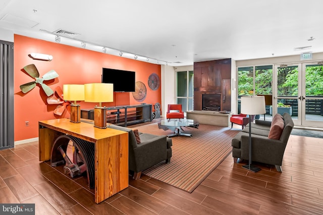 2007 Clipper Park Rd Unit 114, Baltimore, MD 21211 - living room featuring wood tiled floors, rail lighting, and baseboards