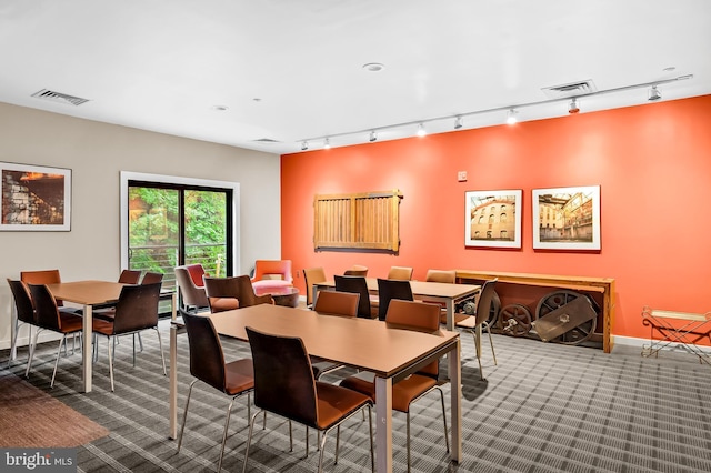 2007 Clipper Park Rd Unit 114, Baltimore, MD 21211 - dining space featuring rail lighting, carpet, and baseboards