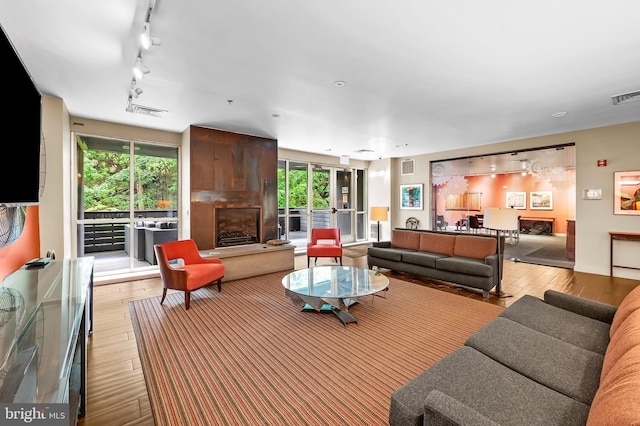 2007 Clipper Park Rd Unit 114, Baltimore, MD 21211 - living area featuring wood-type flooring, healthy amount of natural light, and track lighting