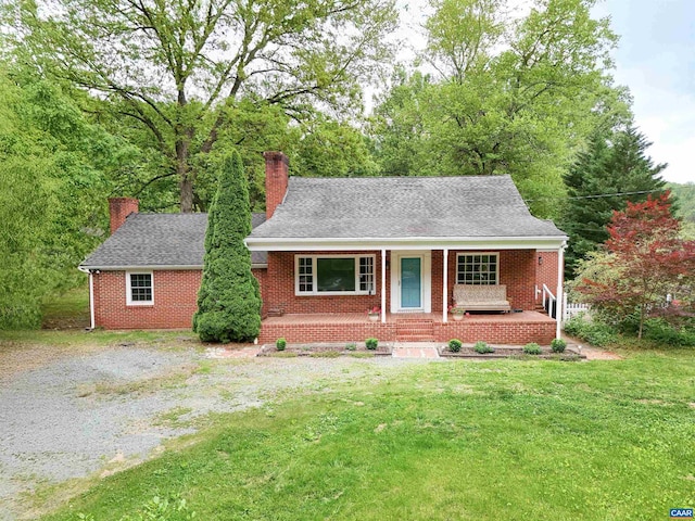 2659 Scottsville Rd, Charlottesville, VA 22902 - view of front facade featuring covered porch, a chimney, brick siding, a front yard, and a shingled roof