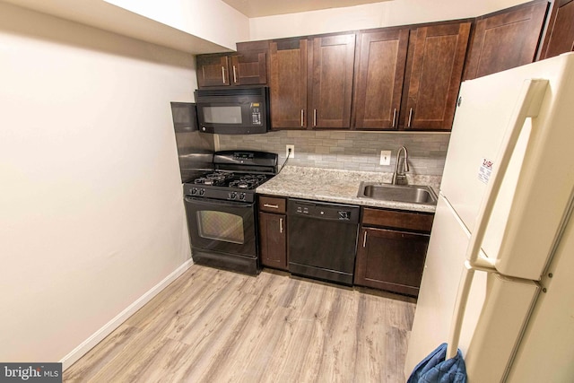 5 Canterbury Sq Unit 201, Alexandria, VA 22304 - kitchen featuring black appliances, a sink, tasteful backsplash, light countertops, and dark brown cabinetry