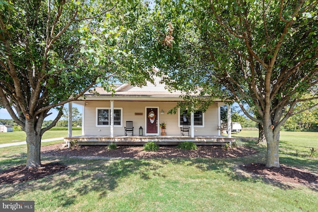 34602 Roxana Rd, Frankford, DE 19945 - farmhouse-style home with a front yard and covered porch