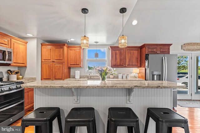 34602 Roxana Rd, Frankford, DE 19945 - kitchen with stainless steel appliances, plenty of natural light, a kitchen breakfast bar, recessed lighting, and wood finished floors