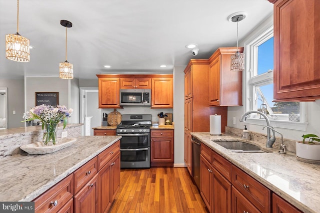 34602 Roxana Rd, Frankford, DE 19945 - kitchen with stainless steel appliances, a sink, light wood-type flooring, light stone counters, and recessed lighting