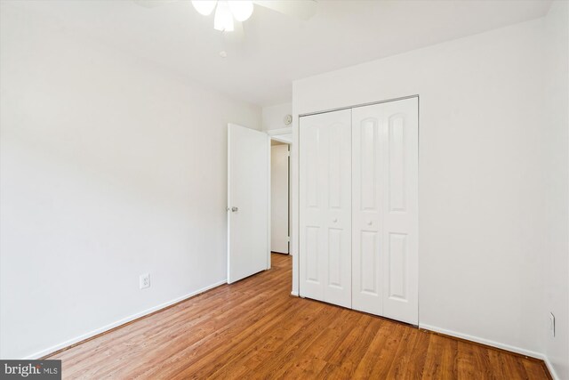 19439 Brassie Pl Unit 101, Gaithersburg, MD 20886 - unfurnished bedroom with a closet, wood finished floors, and baseboards