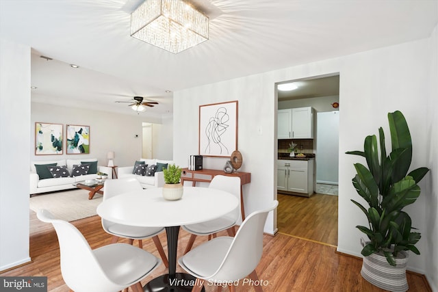 19439 Brassie Pl Unit 101, Gaithersburg, MD 20886 - dining space featuring light wood-style floors and a chandelier