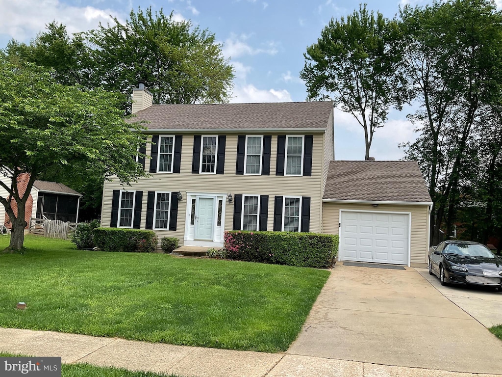 1345 Sweetbriar Ln, Bel Air, MD 21014 - colonial-style house with a garage, driveway, a chimney, a front lawn, and a shingled roof